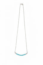 Necklace with turquoise beads on a white background