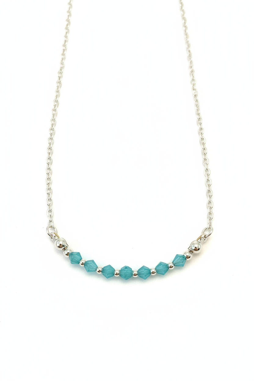 Aqua Bloom Necklace - Faceted blue beads centered on a delicate silver chain.