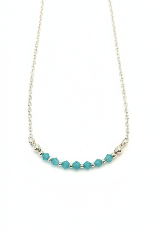 Aqua Bloom Necklace - Faceted blue beads centered on a delicate silver chain.