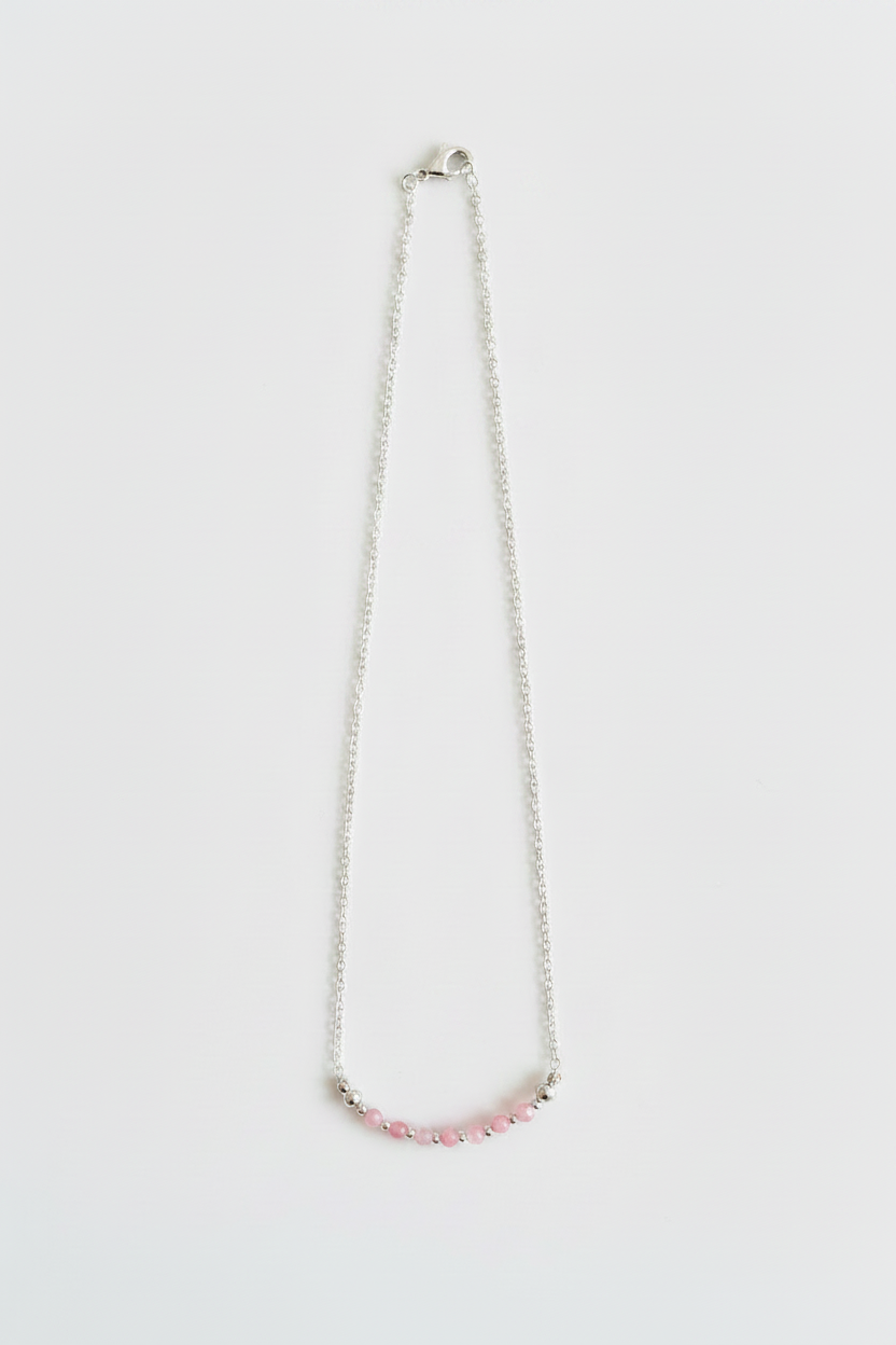 Necklace with pink beads on a white background