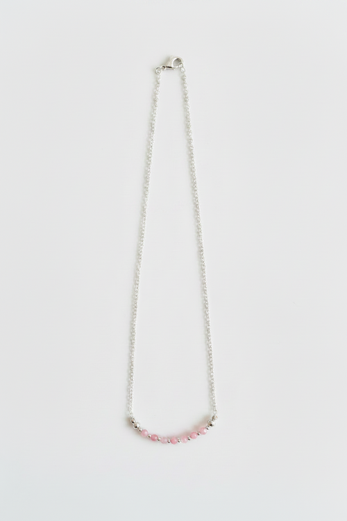 Necklace with pink beads on a white background