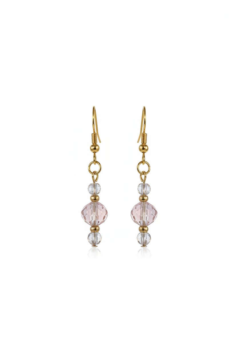 Gold earring with pink gemstone on a white background