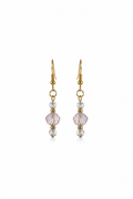 Gold earring with pink gemstone on a white background
