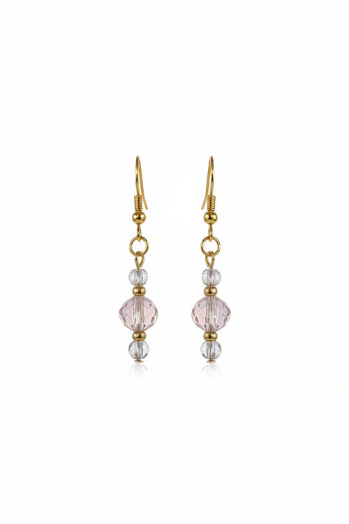 Gold earring with pink gemstone on a white background
