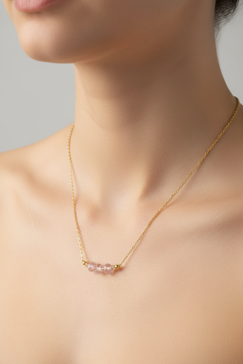 Blush Glow Necklace - Faceted blush-pink beads centered on a delicate gold chain