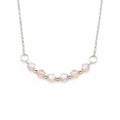 A silver chain necklace featuring a curved row of faceted iridescent beads in soft pink and white, separated by small silver spacer beads, with two silver O-ring connectors, shown on a plain white background.