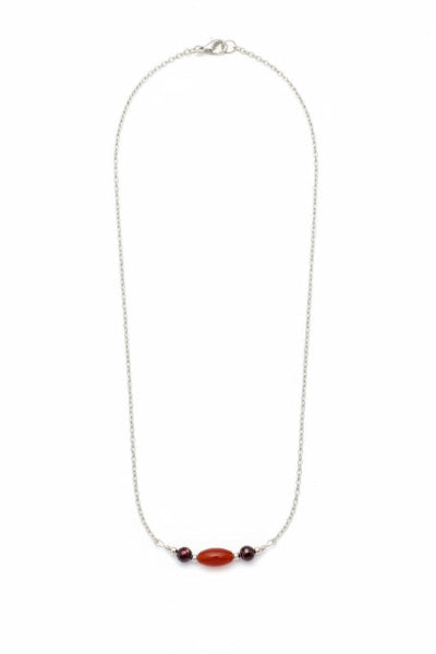 Necklace with red beads on a white background