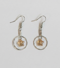 A pair of silver-toned dangle earrings with circular hoops and small starfish charms, shown on a plain light background.