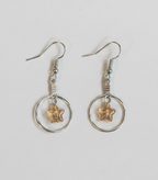 A pair of silver-toned dangle earrings with circular hoops and small starfish charms, shown on a plain light background.
