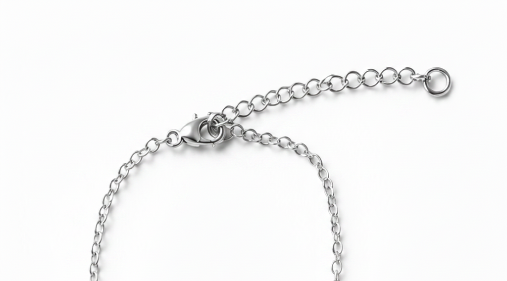 Close-up of a silver lobster clasp, extender chain, shown on a plain white background.