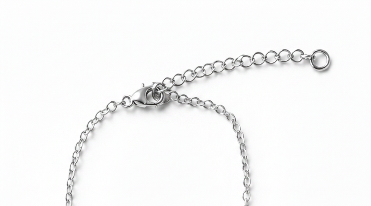 Close-up of a silver lobster clasp, extender chain, shown on a plain white background.