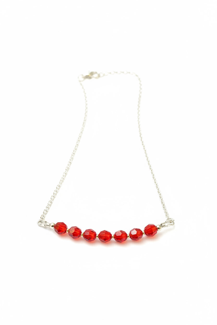Necklace with red beads on a white background
