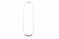 A delicate silver chain necklace featuring a short section at the bottom adorned with small red and blue beads, shown against a plain white background.
