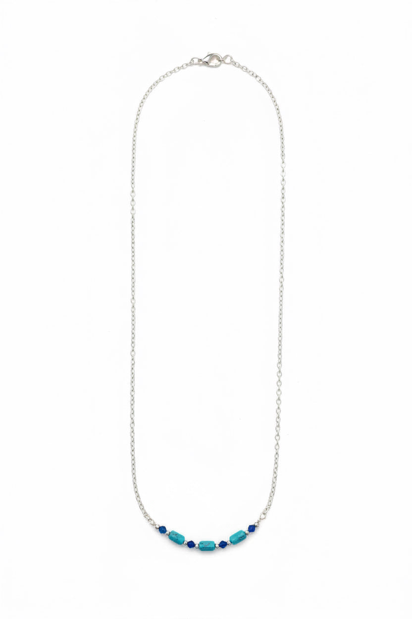 Necklace with blue beads on a white background
