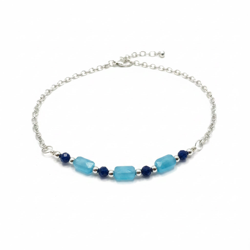 Silver bracelet with blue and navy beads on a white background