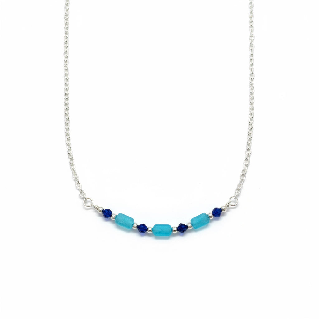 Necklace with blue and navy beads on a white background