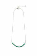 Necklace with green beads on a white background