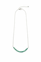 Necklace with green beads on a white background