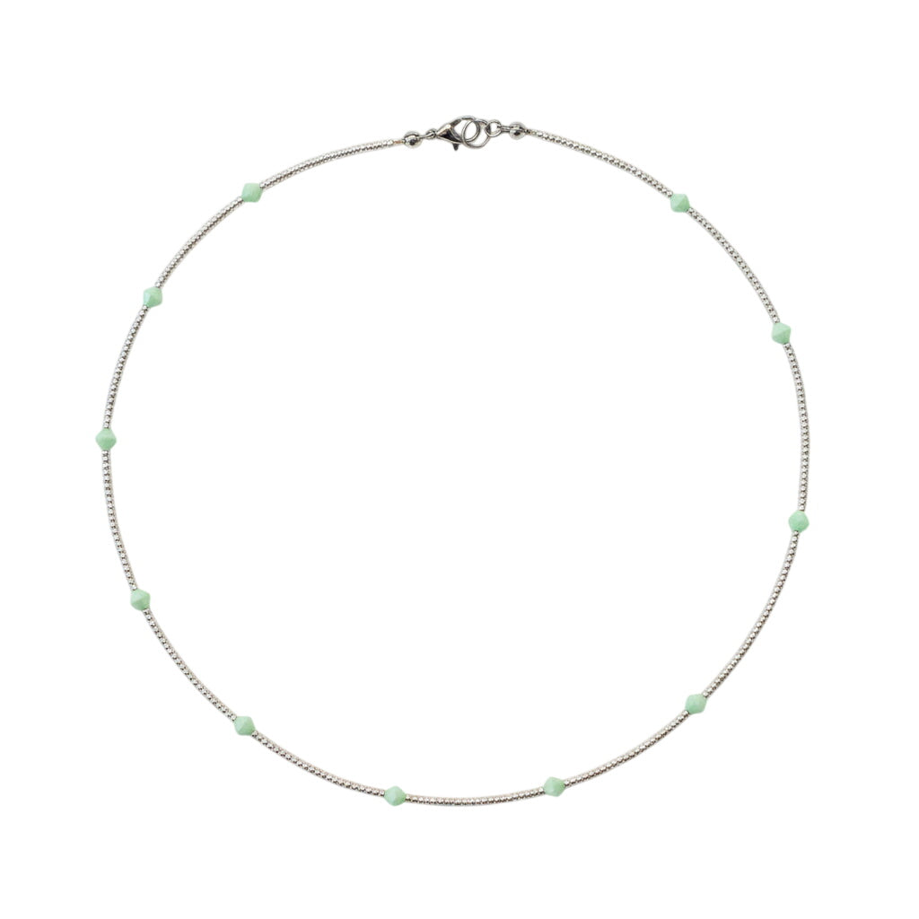 Necklace with small green beads on a white background