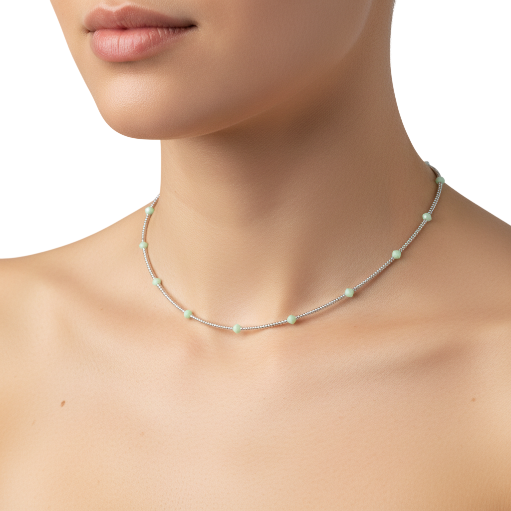 Necklace with small beads worn by a model on a white background