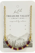 Treasure Valley Creations gold chain necklace with rectangular garnet and gold-tone cube beads, displayed on its branded jewelry card.