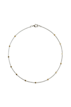 Gold cube beads along strand of silver seed beads.