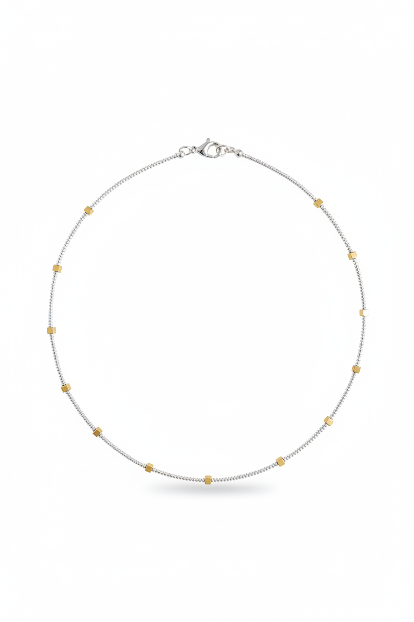 Gilded Thread Necklace | Gold cube beads spaced along a strand of silver.