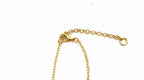 A close-up of a gold chain extender with a lobster clasp and a small ring, shown on a plain white background.