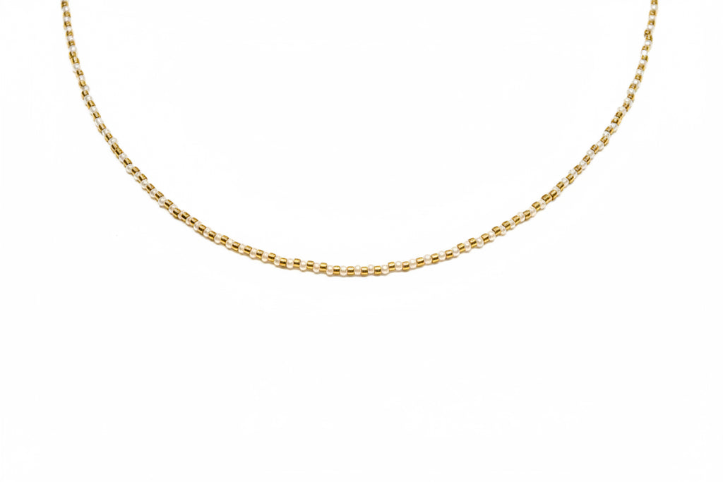 Gold chain necklace on a white background