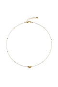 Pearl necklace with gold clasp on a white fabric background