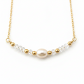 Golden Pearl Necklace - Delicate gold necklace featuring a pearl centerpiece with crystal and gold accents.