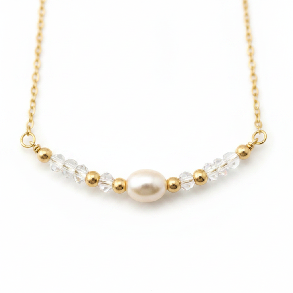Golden Pearl Necklace - Delicate gold necklace featuring a pearl centerpiece with crystal and gold accents.