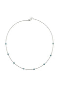 Necklace with small beads on a beige fabric background