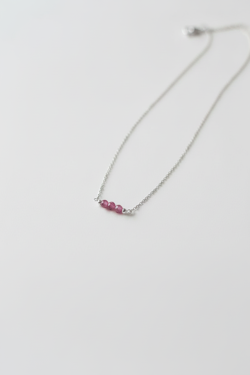 Necklace with pink beads on a white background