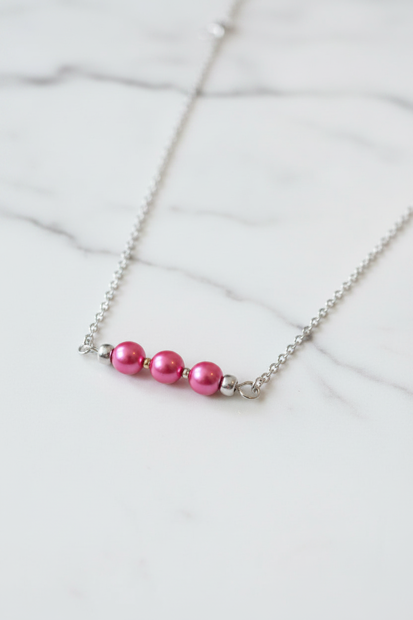 Necklace with pink beads on a white background