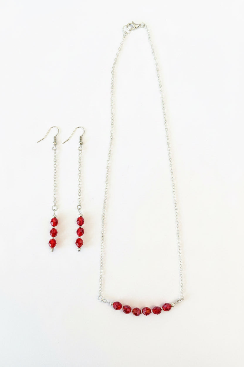 Crimson Bloom Necklace - Red faceted beads suspended on a delicate silver chain.