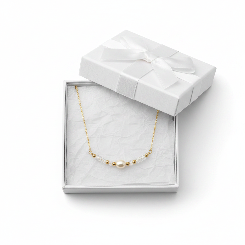 Golden Pearl Necklace - Delicate gold necklace featuring a pearl centerpiece with crystal and gold accents.