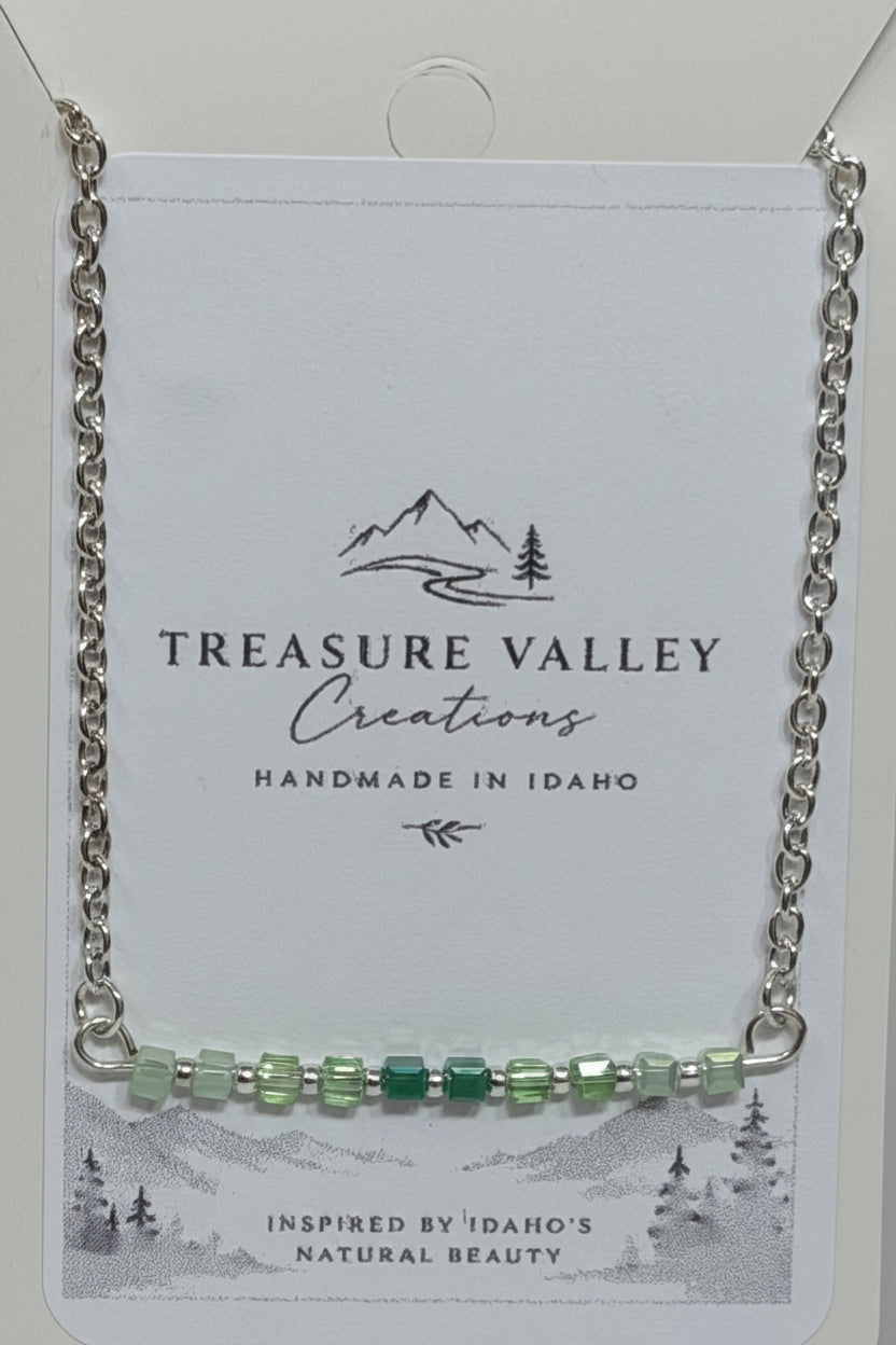 Shades of Green Ombré Necklace - Silver-tone necklace featuring an ombré row of green beads.