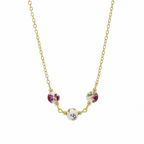 A gold chain necklace featuring three small round floral beads in white, pink, and green, arranged in an arc on a plain white background.