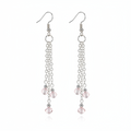A pair of silver-toned dangle earrings with multiple chain strands and small faceted pink beads, shown on a clean white background.
