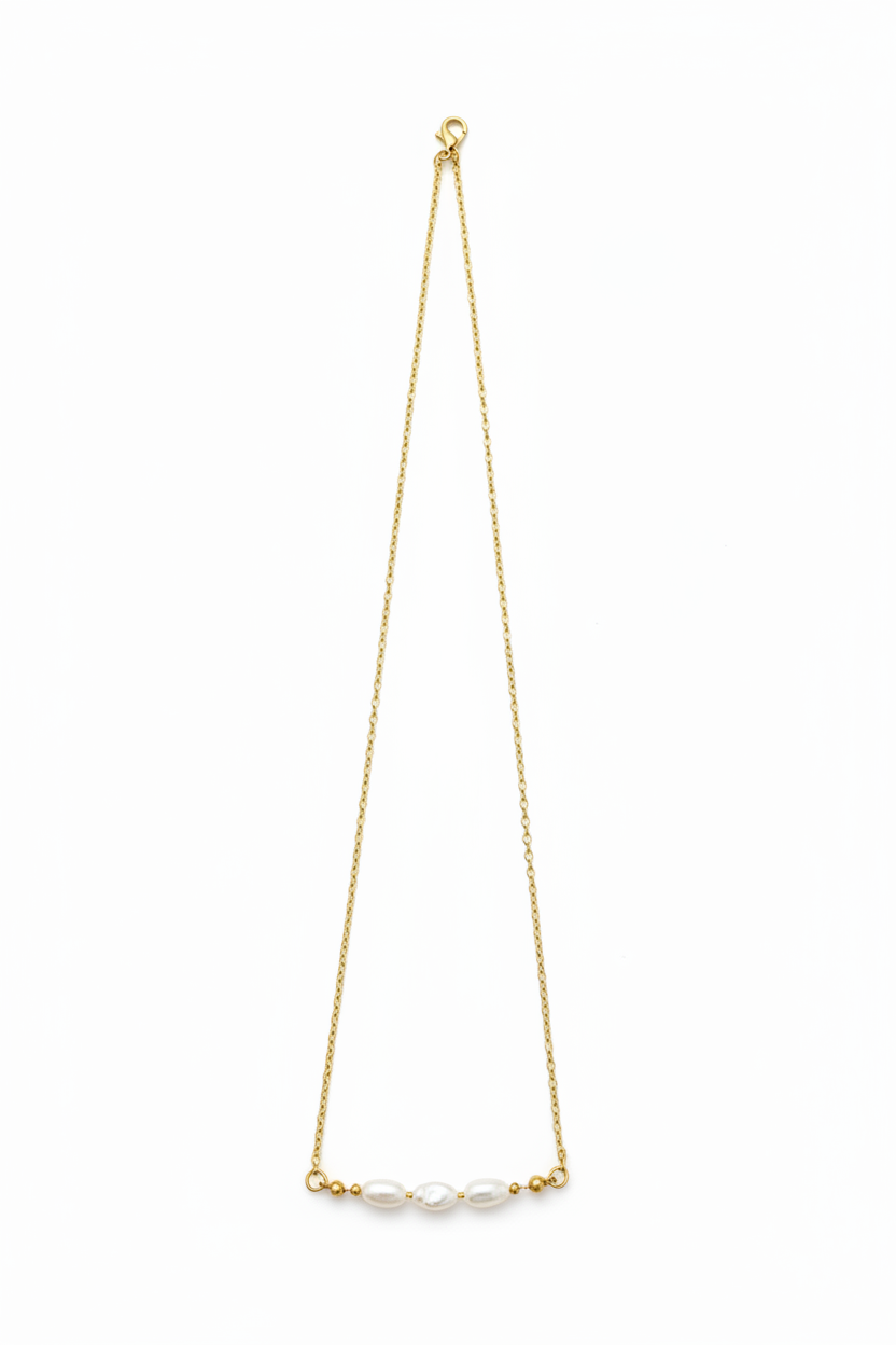 A delicate gold necklace featuring three luminous ivory pearls. Elegant, timeless, and handcrafted for effortless everyday beauty.&nbsp;