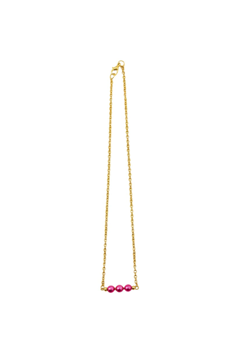 Gold necklace with pink beads on a white background