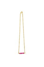 Gold necklace with pink beads on a white background