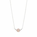 A delicate silver chain necklace featuring a single round, faceted pale pink gemstone pendant held by small silver beads on a white background.
