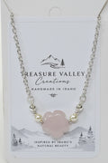A silver chain necklace with a central pale pink cloud-shaped stone and small pearl-like beads, displayed on a white Treasure Valley Creations card.