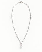 A silver-toned chain necklace with multiple iridescent crystal beads and a teardrop-shaped crystal pendant, displayed on a clean white background.