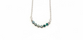 Starlit Cascade Necklace - shimmering blue and emerald-toned star beads on a delicate silver-tone chain.
