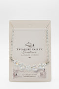 Treasure Valley Creations handmade silver necklace with star-shaped beads, displayed on its original cream-colored backing card.