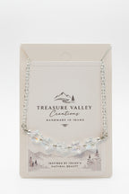 Treasure Valley Creations handmade silver necklace with star-shaped beads, displayed on its original cream-colored backing card.