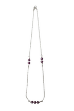 Necklace with purple beads on a white background